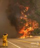 カリフォルニア州北部ウィスキータウン近くで、カー火災の炎を撮影する写真家（2018年7月27日撮影）。(c)AFP PHOTO / JOSH EDELSON